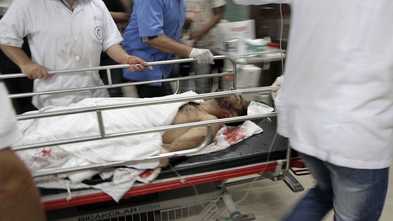 Palestinian medics tend to a man wounded during Israeli air strikes in Gaza on June 23, 2012.