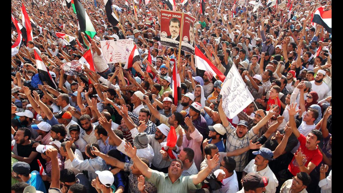 Muslim Brotherhood supporters cheer in Cairo's Tahrir Square on Sunday after hearing of Morsi's victory in Egypt's presidential election.