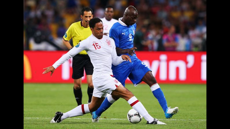 Joleon Lescott of England challenges Mario Balotelli of Italy.