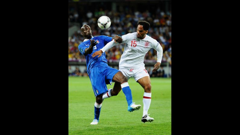 Mario Balotelli of Italy challenges Joleon Lescott of England.