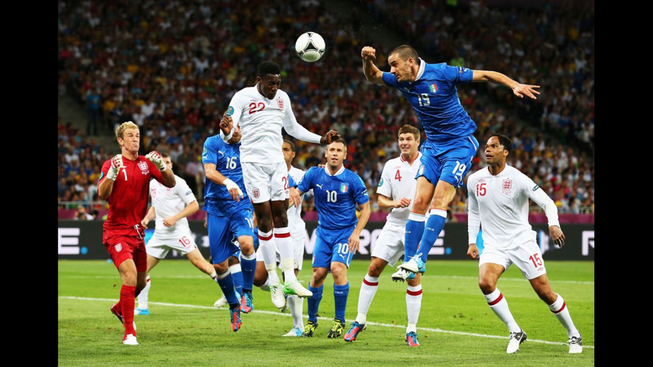 Danny Welbeck of England and Andrea Barzagli of Italy jump for the ball.