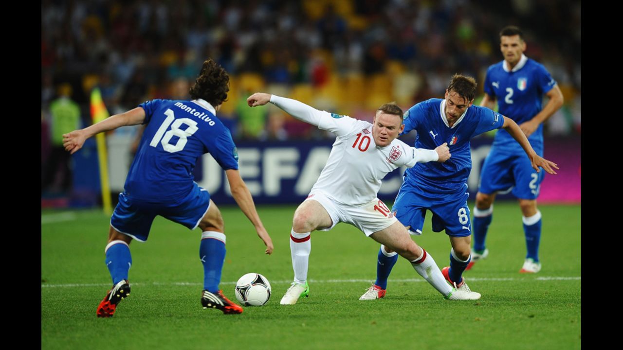 England's Wayne Rooney maneuvers against Italy.
