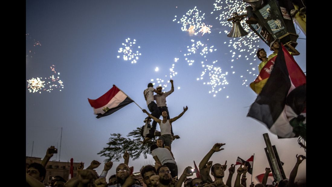 As fireworks burst overhead, Egyptians in Tahrir Square celebrate Mohamed Morsi's election on Sunday.