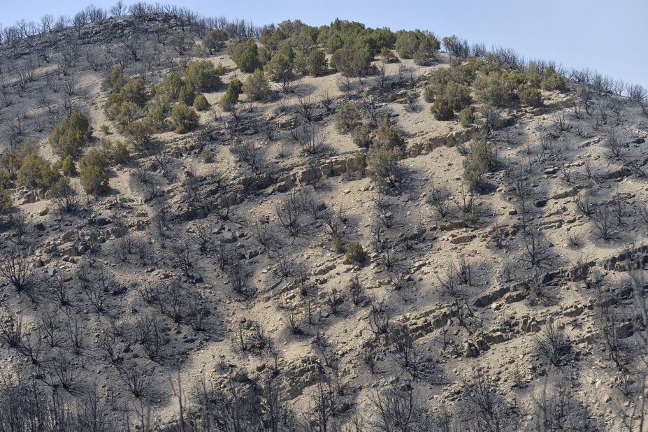 Burned-out terrain from the Dump Fire fills a hillside near Saratoga Springs, Utah on Saturday.