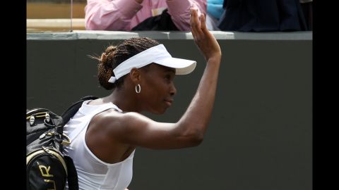 A dejected Williams waves to the crowd after her first-round loss on June 25.