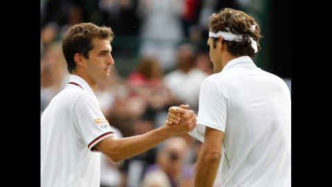Federer, right, shakes hands with Ramos after winning.  