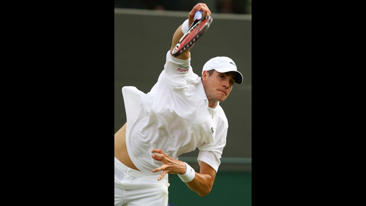 America's John Isner of returns a shot during his men's singles first round match against Alejandro Falla of Colombia.