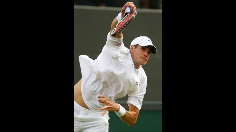 America's John Isner returns a shot during his men's singles first-round match against Alejandro Falla of Colombia June 25.