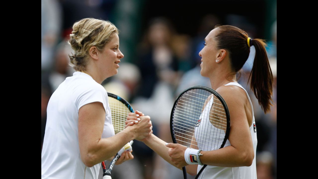 Kim Clijsters of Belgium, left, celebrates match point and is congratulated by Jelena Jankovic of Serbia after their women's singles first round match.