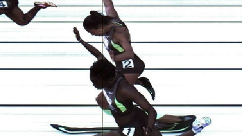 Jeneba Tarmoh, foreground, and Allyson Felix cross the finish line Sunday in the women's 100 meters in Eugene, Oregon.