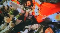 Three Chinese astronauts in the Shenzhou-9 spacecraft prepare for docking with the Tiangong-1 module on July 18, 2012.