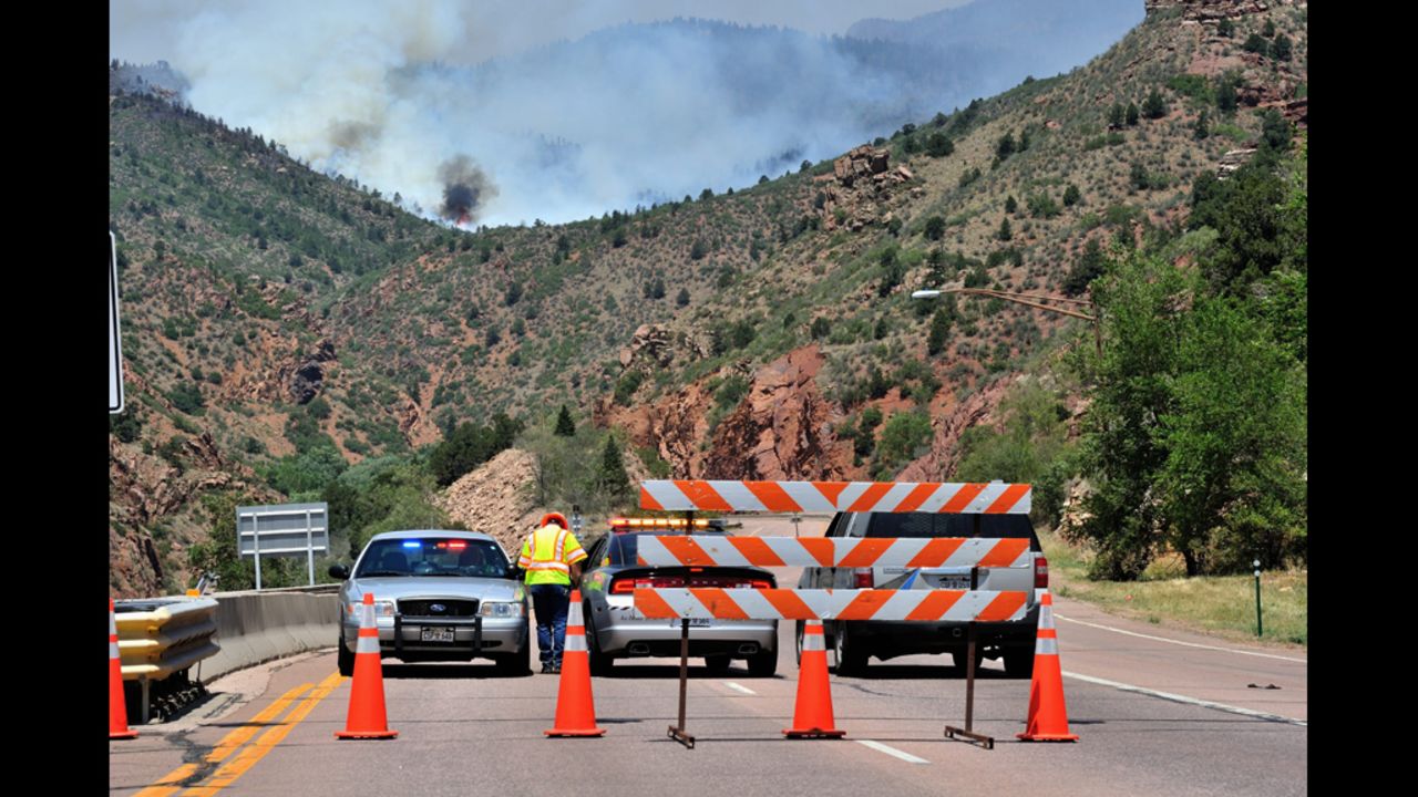 Colorado State Patrol and Colorado Department of Transportation personnel set up a roadblock west of Manitou Springs, Colorado, on Monday, June 25.