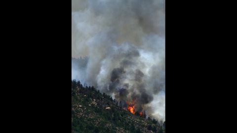 A portion of the Waldo Canyon fire burns out of control in the hills west of Manitou Springs on Monday.