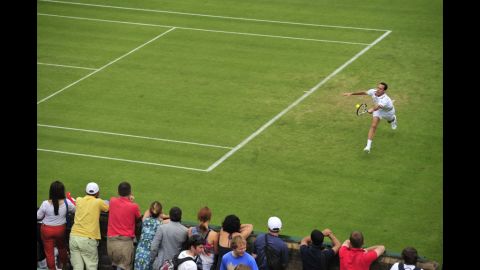 France's Michael Llodra plays a forehand shot during his first-round men's singles match against Italy's Fabio Fognini on June 25.