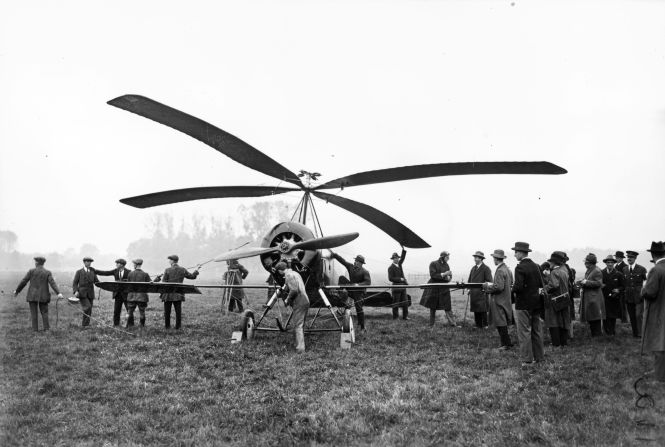 Another air innovation gets an outing at Farnborough in 1925 as test pilot Frank Courtney talks with officials and reporters at the aerodrome before taking an "autogiro" for a flight.