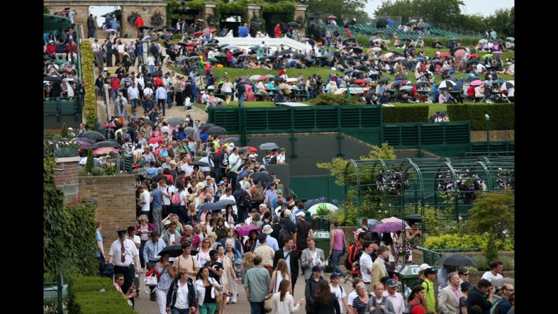 Crowds stream into the All England Lawn Tennis Club for the second day of play June 26.