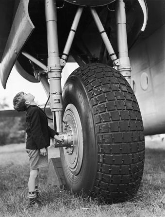 Eight-year-old David Bailey stands by the undercarriage of an Avro York transport plane at the Farnborough Airshow rehearsal in 1950.