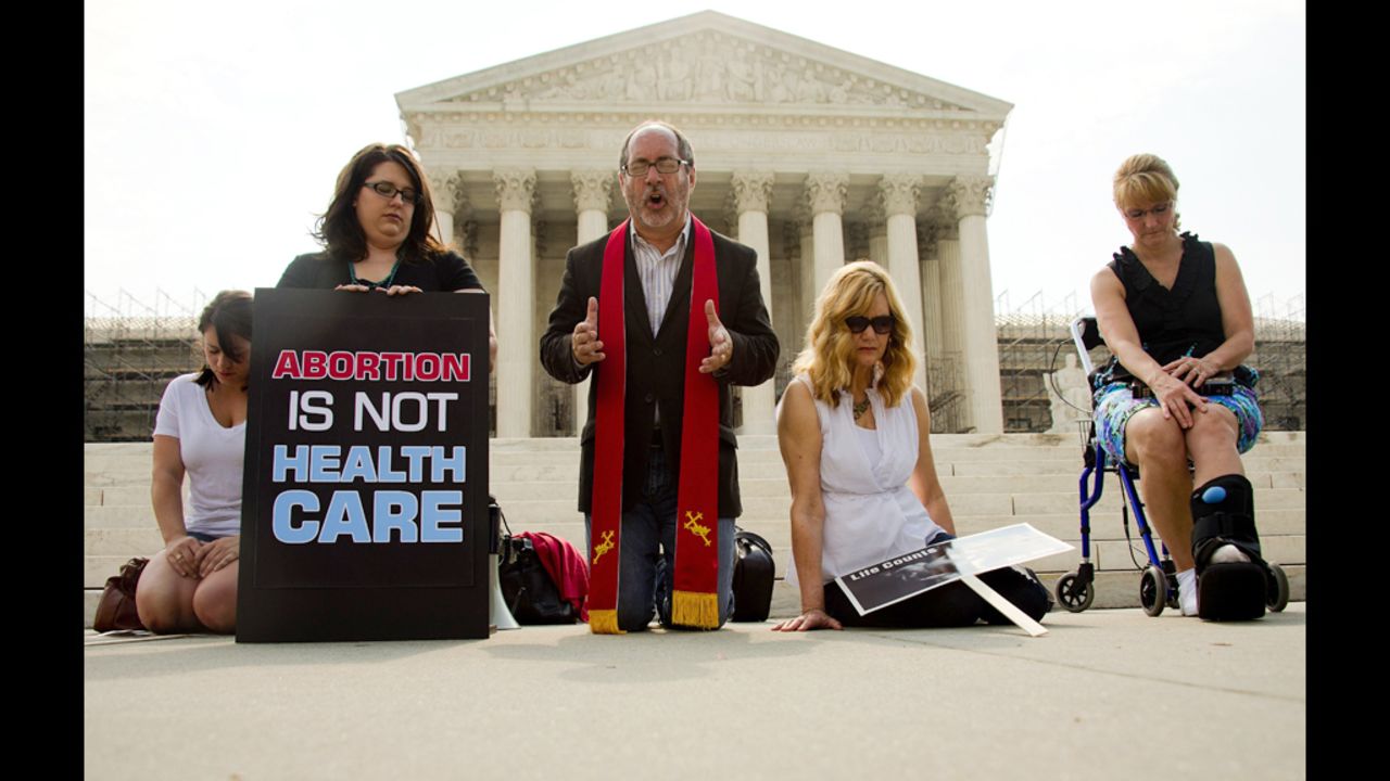 The Rev. Patrick Mahoney leads demonstrators in prayer outside the Supreme Court on Monday, June 25, as they await the court's ruling.