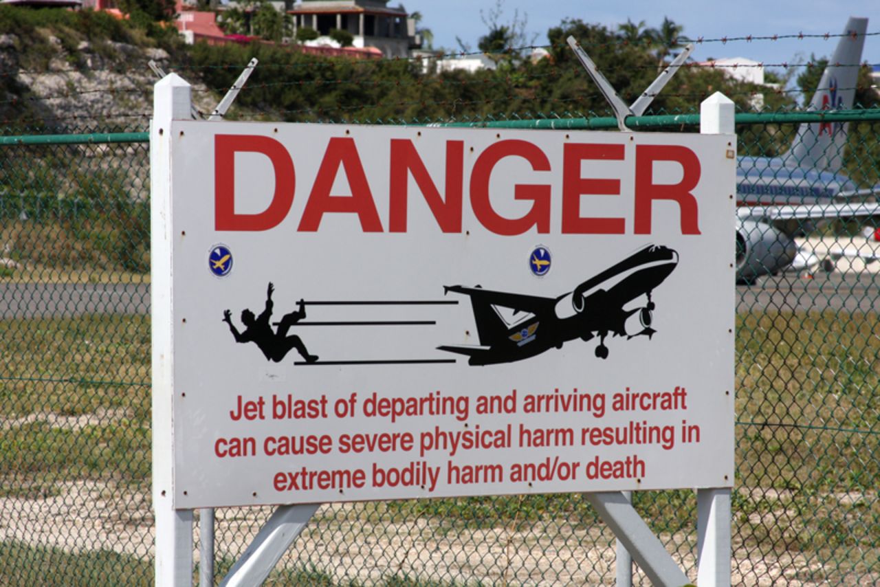 When pilots preparing for take off from St. Maarten's Princess Juliana International Airport rev their engines, daredevils sometimes stand against the airport fence and hold on. The jet blast is so close and powerful that it can throw people off the fence and onto the ground. 