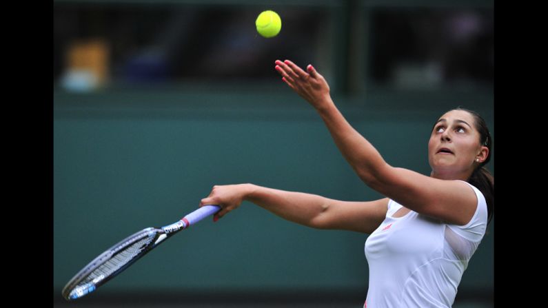 Austria's Tamira Paszek serves during her first round women's singles match against Denmark's Caroline Wozniacki on June 26.