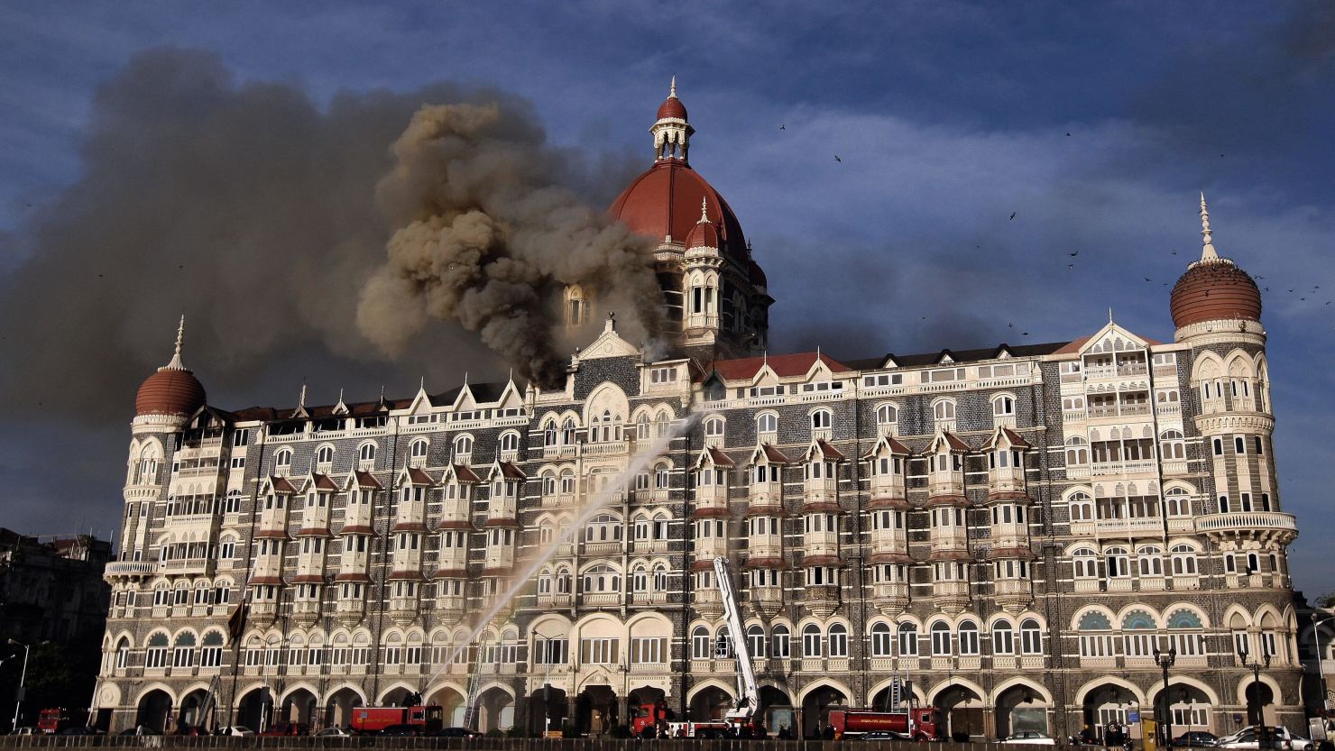 This photograph taken on November 27, 2008, shows Indian firefighters attempting to put out a fire as smoke billows out of the historic Taj Mahal Hotel in Mumbai, one of the sites of attacks by militant gunmen.