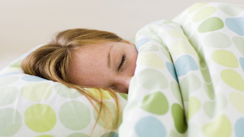woman sleeping under covers