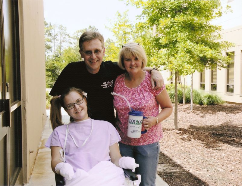 Flesh-eating bacteria patient Aimee Copeland goes outside Doctors Hospital in Augusta, Georgia, for the first time with her parents, Andy and Donna Copeland, on June 25. Copeland was discharged from the hospital in August after a three-month-ordeal.