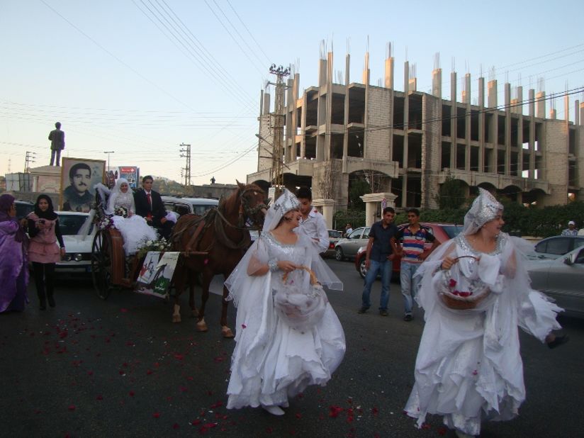 Women dance in the street before a carriage bearing newlyweds affiliated with YNCA. The organization used the occasion to declare a "week of joy," and encouraged people to celebrate by dancing in the street, defying prohibitions against such behavior that have arisen in recent years.