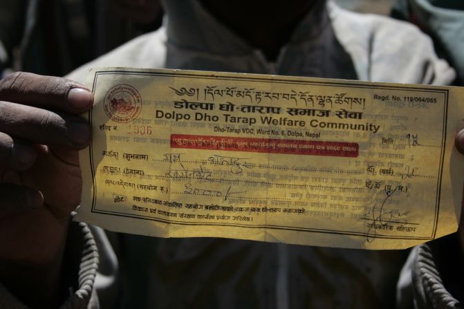 A harvester holds up his tax receipt. Citizen committees in Dolpa levy taxes on migrant harvesters in an effort to buoy the local economy and fund environmental clean-up activities.