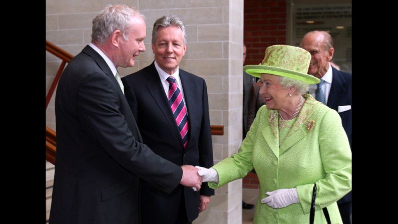 An historic moment was made when <a href="index.php?page=&url=http%3A%2F%2Fedition.cnn.com%2F2012%2F06%2F26%2Fworld%2Feurope%2Fnorthern-ireland-mcguinness-queen-handshake%2F">Queen Elizabeth II</a> shook  hands with Northern Ireland Deputy First Minister Martin McGuinness as First Minister Peter Robinson looks on at the Lyric Theatre in Belfast, Northern Ireland, on June 27, 2012. A simple handshake marks a step forward in the peace process relating to British rule of Northern Ireland. 
