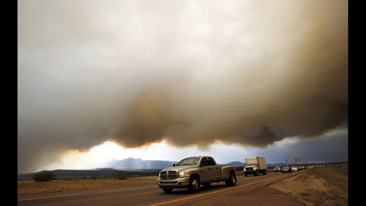 Evacuees drive under a shroud of smoke from the Waldo Canyon Fire on Tuesday.