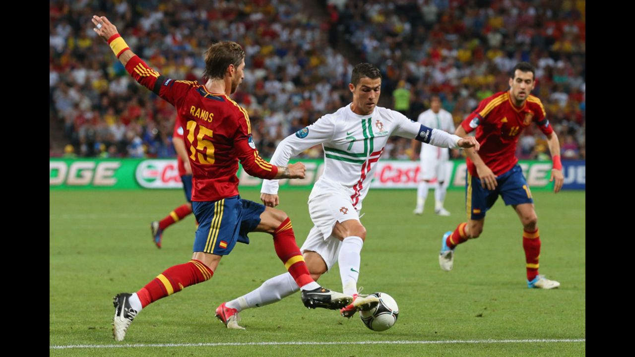 Sergio Ramos of Spain challenges Cristiano Ronaldo of Portugal