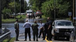 Emergency crews work the scene of a flooded street, where Pasco County Sheriff's Office Public Information Officer Doug Tobin confirms they are attempting to recover an unidentified body in New Port Richey, Florida, on Wednesday, June 27. Debby weakened to a tropical depression after it drifted ashore on Florida's Gulf Coast on Tuesday.