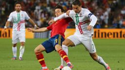 David Silva of Spain competes with Cristiano Ronaldo of Portugal during the Euro 2012 semi-final match at Donbass Arena