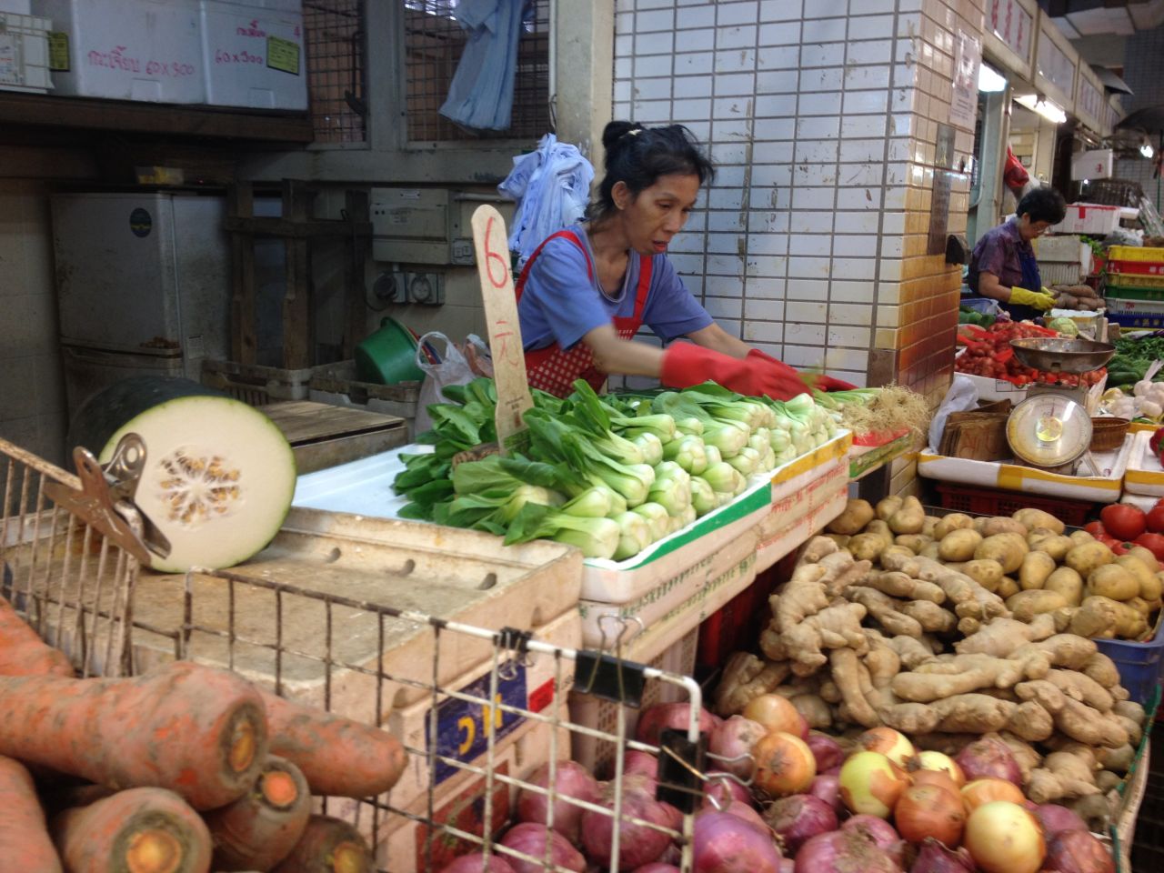 Carmen, 56, works at a vegetable stall she inherited from her mother when she died in 1999. She said that after the handover to China, the rules became stricter and outdoor vendors had to move indoors. Business isn't as strong inside, she said.
