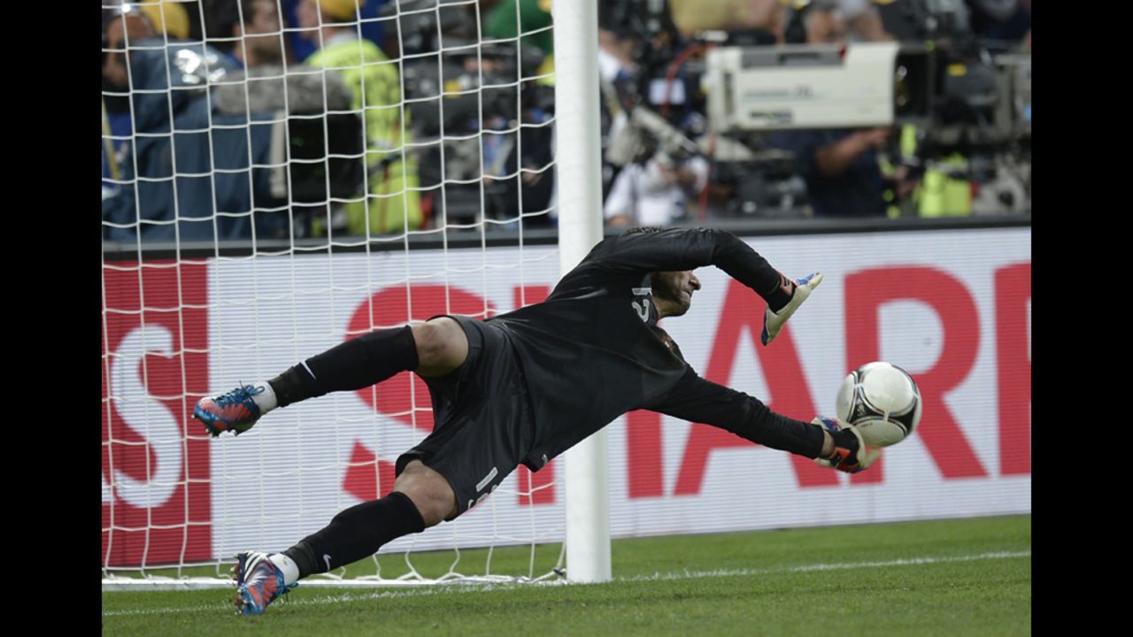 Portuguese goalkeeper Rui Patricio stops a shot during the penalty shootout.