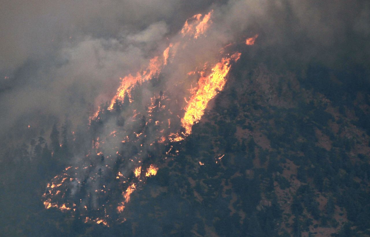 A portion of the Waldo Canyon Fire moves across a hillside above a subdivision west of Colorado Springs on Tuesday.