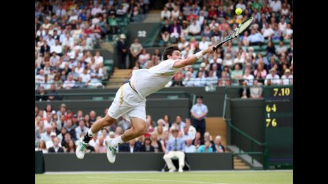 Jamie Baker of Great Britain dives for a backhand return during his first-round match against Andy Roddick of the United States on Wednesday, June 27, at Wimbledon.