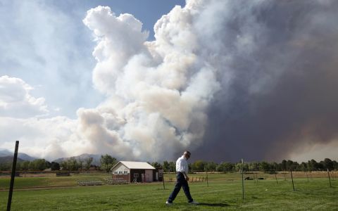 A large plume of smoke from the Waldo Canyon Fire fills the sky west of Colorado Springs on Tuesday.