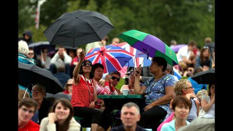 The crowd takes shelter from showers on day three of Wimbledon.