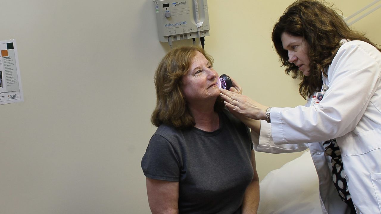  Dermatologist Jonette Keri examines Marcia Spevak Breiter for symptoms of skin cancer.