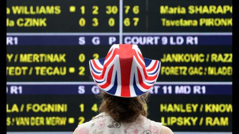 A fan studies the scoreboard at the Wimbledon championships at the All England Lawn Tennis Club in London June 28
