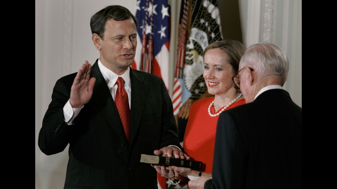 As his wife Jane holds the Bible, Chief Justice John Roberts is sworn in by Associate Justice John Paul Stevens during a ceremony at the White House on September 29, 2005. Roberts became the 17th chief justice after the Senate voted 78-22 to confirm his appointment.