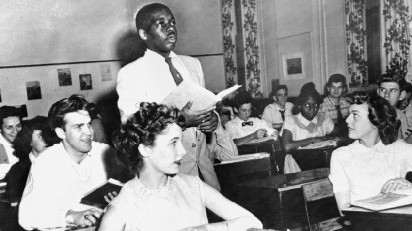 A black student, Nathaniel Steward, 17, surrounded by white fellows and others black students, 21 May 1954 at the Saint-Dominique school, in Washington, where for the first time in USA the Brown v Board of Education decision which outlaws segregation in state schools is applied. The Supreme Court decision overturned the Plessy v. Ferguson ruling in 1896 that allowed "separate but equal" public services.  