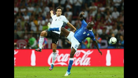Mario Balotelli, right, of Italy battles for the ball with Mats Hummels of Germany.