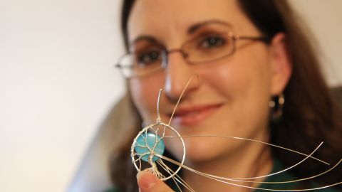 Turner says she was laid off for health-related absences and now makes a living with her hand-made jewelry business.