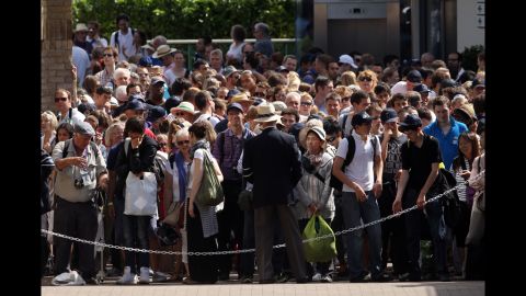 Fans gather to enter the All England Lawn Tennis Club in London for the Wimbledon championships on June 28.