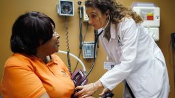 Brenda Major (L), who said she had a pre-existing condition that made it impossible to find insurance that would cover her until the Affordable Care Act, is examined by Dr. Fernanda Mercade during a routine checkup at the Jessie Trice Center for Community Health clinic on March 22, 2012 in Miami, Florida. Starting on March 26, 2012 the arguments begin on the Affordable Care Act before the U.S. Supreme Court. The Act, which was set into law by U.S. President Barack Obama, helps many in need of health care like Brenda Major who now has insurance after being denied health insurance coverage due to her pre-existing condition. (Photo by Joe Raedle/Getty Images) 