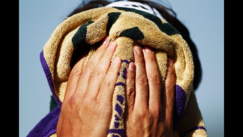 Marcos Baghdatis of Cyprus wipes his face during a match Thursday, June 28.