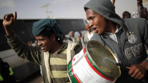 Sudanese men protest on the road through a United Nations displacement camp. 